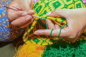 Kochet with green and yellow knitting thread photo