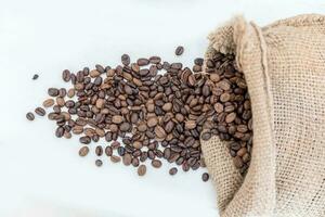 coffee beans in bag isolated on white background photo