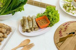 Fried Vietnamese Spring Rolls surrounded by  food Vietnamese photo