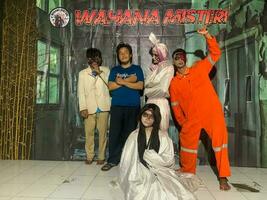 Surabaya, indonesia - 22 june 2023 - the peoples who dress up become ghosts with the visitors in horror show photo