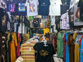 Surabaya - indonesia - 2023 - the view of clothes displayed and hung for sale to buyers photo