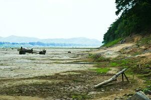 Agricultural vehicles parked in a dry river photo