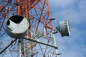 close up telecommunications tower with a blue sky photo