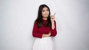 A thoughtful young woman wearing red t-shirt while looking aside, isolated by white background video