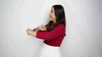 Young happy Asian woman dancing having fun alone isolated by white background video