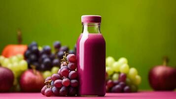 Grapes smoothie in a bottle isolated on background with a copy space photo