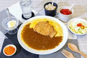 curry rice with tonkatsu fried pork cutlet and creamy omelet - Japanese food style photo