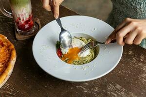 Pasta spaghetti with pesto sauce in bowl. Light grey background.Top view. Egg and bacon spaghetti carbonara. photo