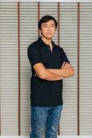 Portrait of a man Asian standing in black t-shirt and shorts. Isolated  on background with copy space and clipping path photo