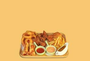 tasty crunchy onion ring, french fries, sausage, fried cheese, pacanga pastry, hot snack plate. Special spice photo