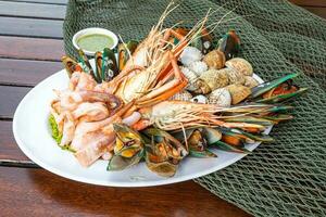 Seafood prawns prawns mussels clams on plate and dark background-cooked food photo