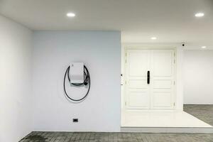 New charging station for electric car on wall at home, charging pillar with copy space , space for text photo