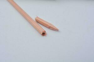 Broken pencil, close up of used pencil on white background with clipping path photo