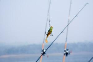 three fishing rods in the river photo