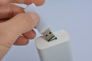 Connecting a thumb drive, white background photo