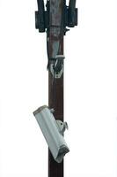 Broken CCTV camera on a power pole isolate photo