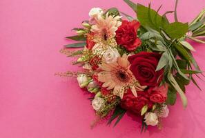 Top View Beautiful Fresh Bouquet Of Flowers For Bride Or Occasion On Pink Table, Copy Space. Colorful Mixed Gerbera, Roses, Chrysanthemum, Carnation Shabot, Green Leaves, Gerber. Horizontal Plane photo