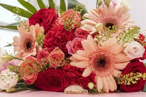 Closeup Beautiful Fresh Bouquet Of Flowers For Bride Or Occasion On Table. Colorful Mixed Roses, Carnation Shabot, Green Leaves, Gerber. Horizontal photo