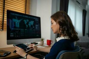 Futuristic women Engineer working with Holographic Augmented Reality and 3D Wind Turbine Model on tablet at home office ,Concept of technology and environment photo