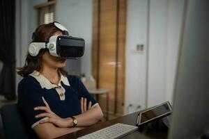 Futuristic women Engineer Wearing Virtual Reality Glasses working with a futuristic hologram to analysis and create alternative energy solutions with wind turbines photo