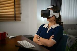 Futuristic women Engineer Wearing Virtual Reality Glasses working with a futuristic hologram to analysis and create alternative energy solutions with wind turbines photo