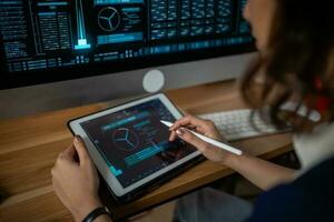 Futuristic women Engineer working with Holographic Augmented Reality and 3D Wind Turbine Model on tablet at home office ,Concept of technology and environment photo