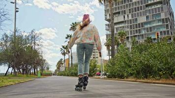 A woman skateboarding down a city street video