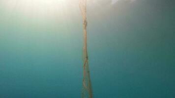 Fishing Net Hanging From Boat Under Sea in Underwater video