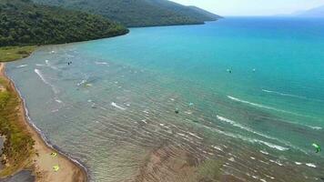 Kiteboarding, Kitesurfing Kiters and Kiteboarders are Pulled Across Sea Water by a Wind Power Kite video