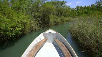 Bow Of Boat Advancing in Narrow River Surrounded By Reeds video