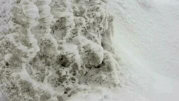 Snow Layers Accumulating on Rock in the Hard Stormy Cold Weather in Winter video