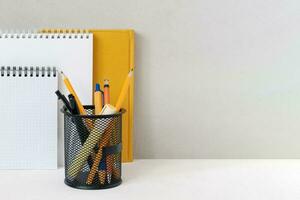 Stationery on the table near the gray wall. Place of study, copy space. photo