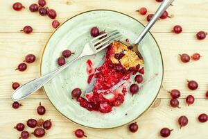 Piece of berry pie on the kitchen table photo