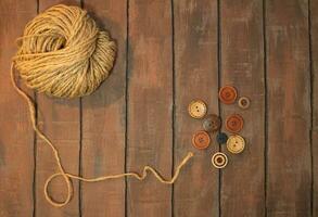 jute twine with buttons on brown boards. Copy space photo