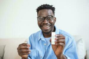 African-American man holding a negative test device. Happy young man showing his negative Coronavirus - Covid-19 rapid test. Coronavirus photo