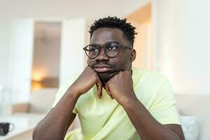 Close up profile view of pensive upset African American man look in distance thinking of personal problems, thoughtful sad biracial male feel depressed lost in thoughts pondering, having dilemma photo