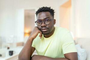 Close up profile view of pensive upset African American man look in distance thinking of personal problems, thoughtful sad biracial male feel depressed lost in thoughts pondering, having dilemma photo