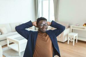 Excited biracial male call center agent in headset have fun laugh working on computer online, overjoyed African American man busy studying or watching funny training webinar on computer gadget photo