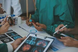 Medical technology network team meeting concept. Doctor hand working smart phone modern digital tablet laptop computer graphics chart interface, sun beams effect photo