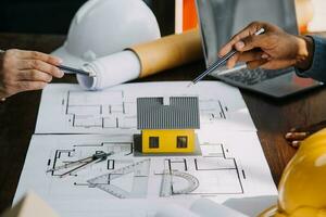 Engineer Teamwork Meeting, Drawing working on blueprint meeting for project working with partner on model building and engineering tools in working site, Construction and structure concept. photo