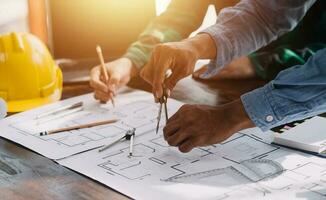 Engineer Teamwork Meeting, Drawing working on blueprint meeting for project working with partner on model building and engineering tools in working site, Construction and structure concept. photo