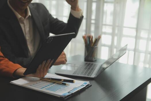 Close up of Business team analyzing income charts and graphs with modern laptop computer. Business analysis and strategy concept. photo