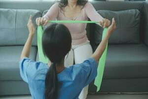 Doctor or physical therapist examines back pain and spinal area to give advice within the rehabilitation center. photo