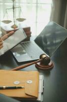 Judge gavel with Justice lawyers having team meeting at law firm background. Concepts of Law and Legal services. photo