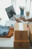 Business woman start up small business entrepreneur SME success .freelance woman working at home with Online Parcel delivery. SME and packaging deliveryconcept photo