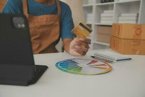 Retail, credit card payment service. Customer paying for order of cheese in grocery shop. photo