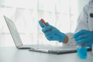 Professional lab. Amazing longhaired medical worker wearing uniform while using microscope during research photo