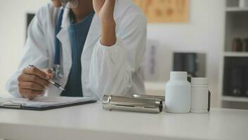 Professional lab. Amazing longhaired medical worker wearing uniform while using microscope during research photo