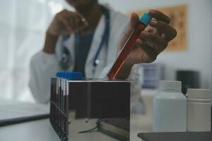 Professional lab. Amazing longhaired medical worker wearing uniform while using microscope during research photo