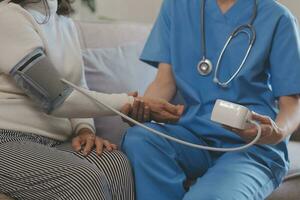 Doctor and patient talking while sitting at the desk in hospital office, closeup of human hands. Medicine and health care concept photo